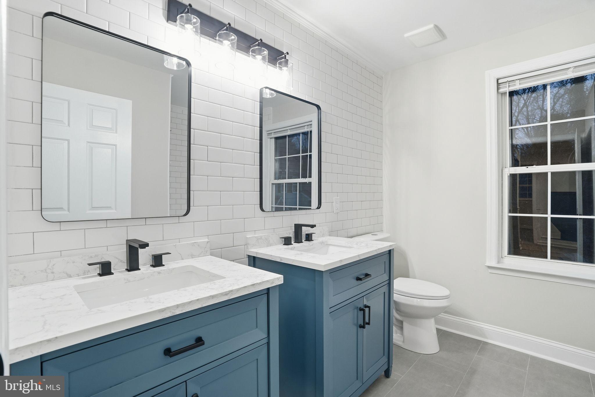 35 Church Road Elkins Park, PA 19027 - Photo 32 of 64 Stylish dual vanities in a modern bathroom.