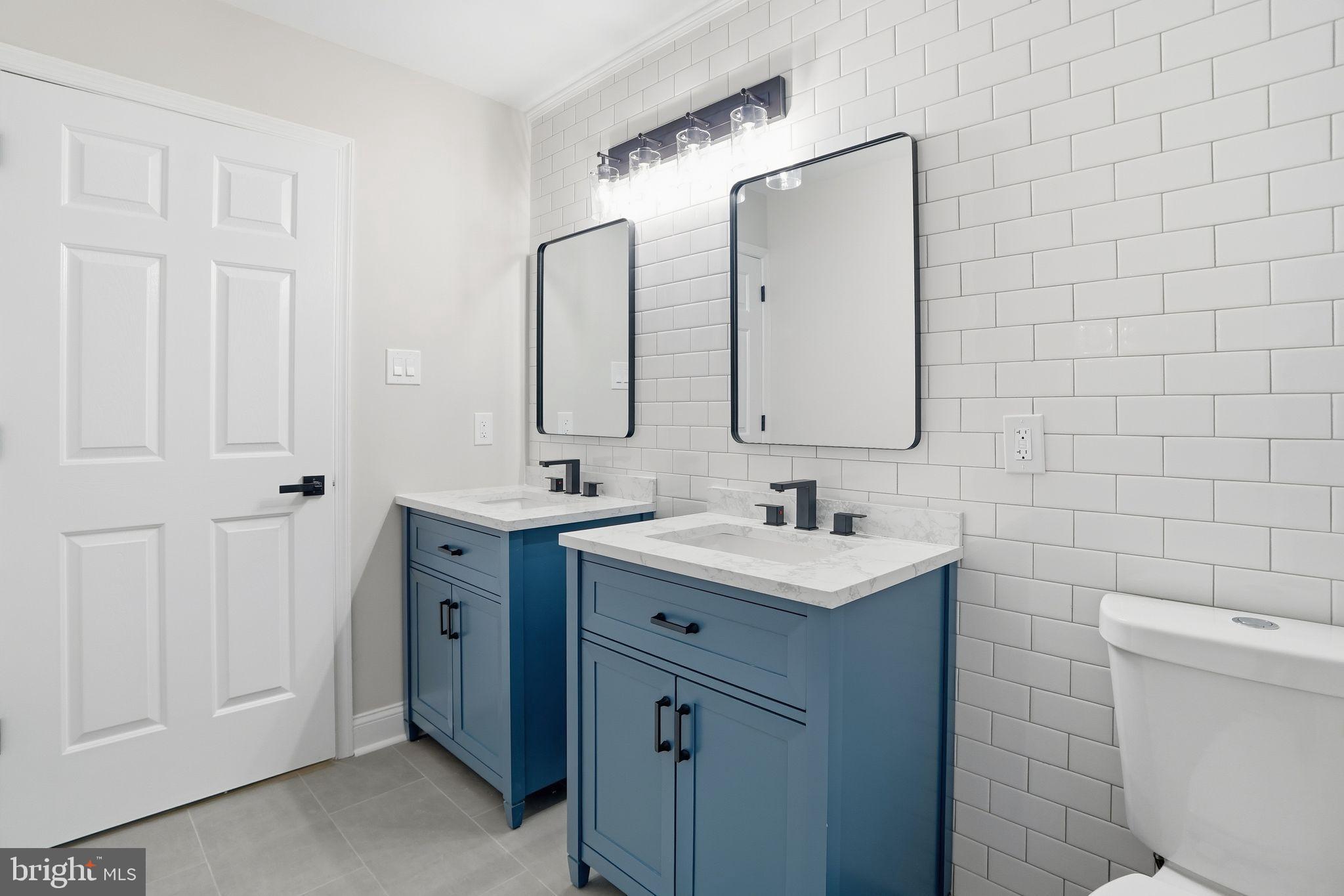 35 Church Road Elkins Park, PA 19027 - Photo 34 of 64 Sleek dual vanities in a modern bathroom.