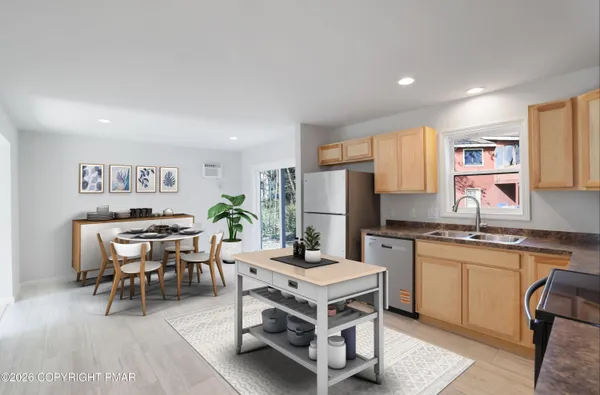 a living room with stainless steel appliances granite countertop furniture and a kitchen view