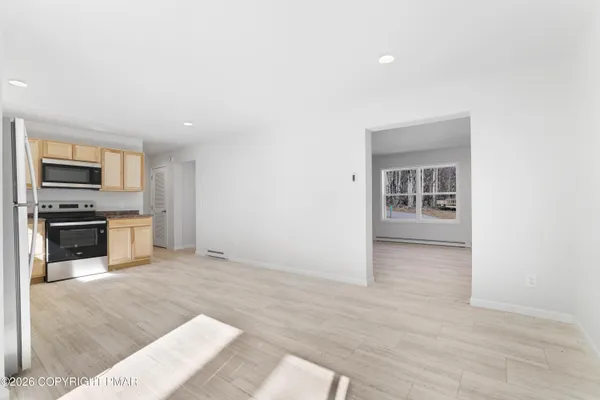 a view of kitchen with sink microwave and stove