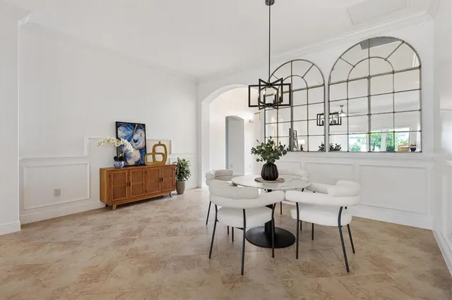 a living room with furniture a chandelier and a table