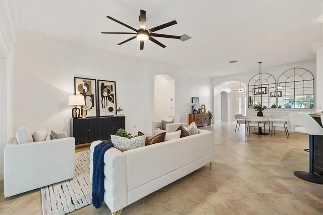 a living room with furniture and kitchen view