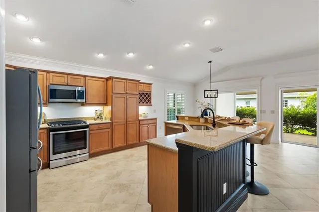 a kitchen with stainless steel appliances granite countertop a sink stove and refrigerator