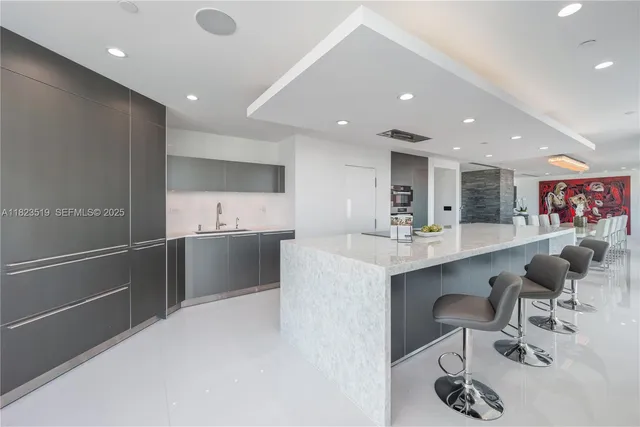 a kitchen with stainless steel appliances a sink and cabinets