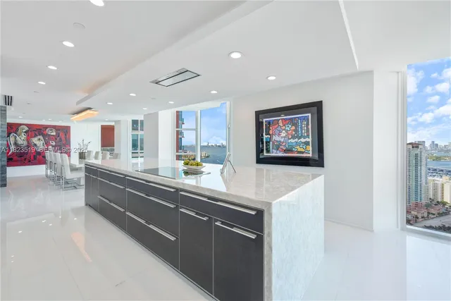 a large bedroom with a large bed and a large window