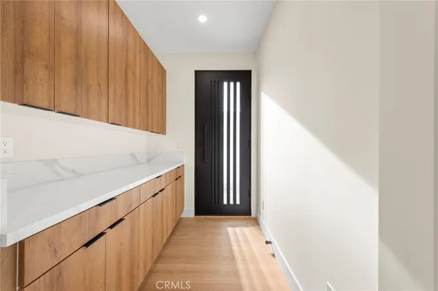 an empty room with wooden floor and a window