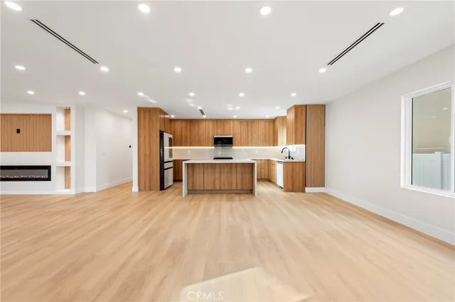 a large kitchen with a lot of counter space and a refrigerator