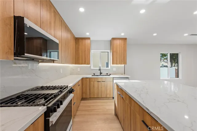 a kitchen with stainless steel appliances granite countertop a stove and a microwave