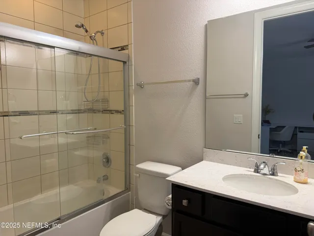 a bathroom with a sink shower and a toilet