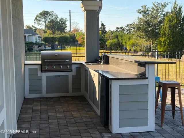 an aerial view of residential houses with outdoor space and swimming pool