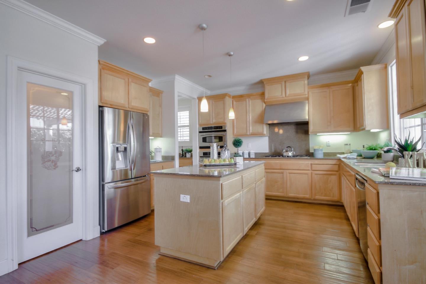 2893 Bethany Road San Ramon, CA 94582 - Photo 11 of 43 a kitchen with stainless steel appliances granite countertop a refrigerator a sink dishwasher a oven and a large island with wooden floor