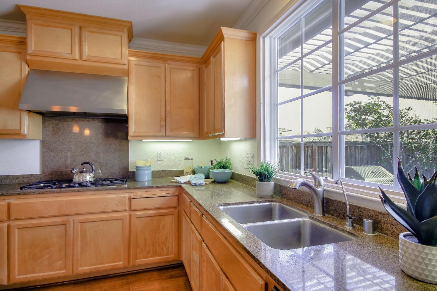 2893 Bethany Road San Ramon, CA 94582 - Photo 14 of 43 a kitchen with stainless steel appliances granite countertop a sink a stove and cabinets