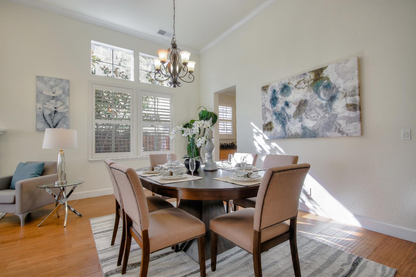 2893 Bethany Road San Ramon, CA 94582 - Photo 16 of 43 a view of a dining room with furniture a chandelier and wooden floor