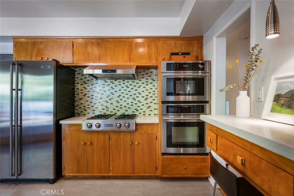 2820 East Chevy Chase Drive Glendale, CA 91206 - Photo 25 of 55 a kitchen with stainless steel appliances granite countertop a stove and a refrigerator