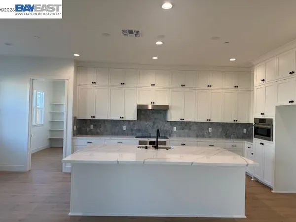 a view of kitchen with stainless steel appliances sink refrigerator and microwave