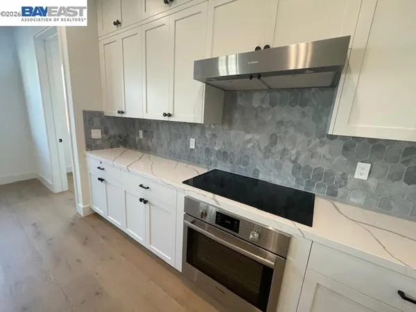 a kitchen with granite countertop a stove and a sink