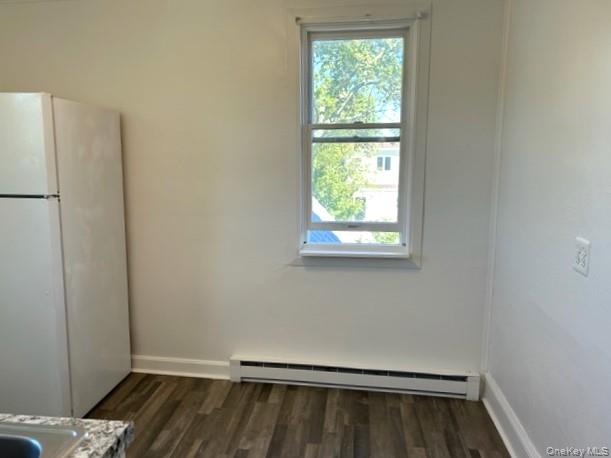 578 South 15th Street, Unit 2 Lindenhurst, NY 11757 - Photo 3 of 8 a view of an empty room with wooden floor and a window