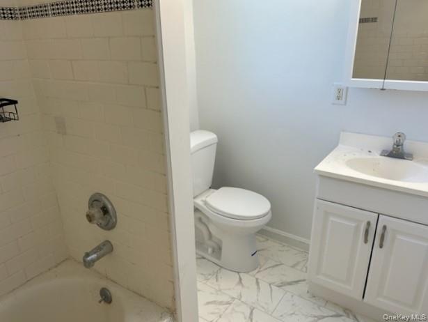578 South 15th Street, Unit 2 Lindenhurst, NY 11757 - Photo 8 of 8 a bathroom with a toilet sink and mirror