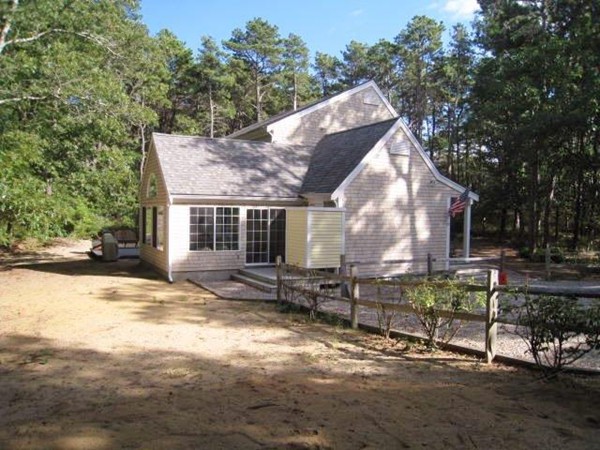 175 Pine Needle Road Wellfleet, MA 02667 - Photo 5 of 23 a view of a house with a yard and sitting area