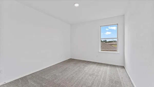 a view of an empty room and a window
