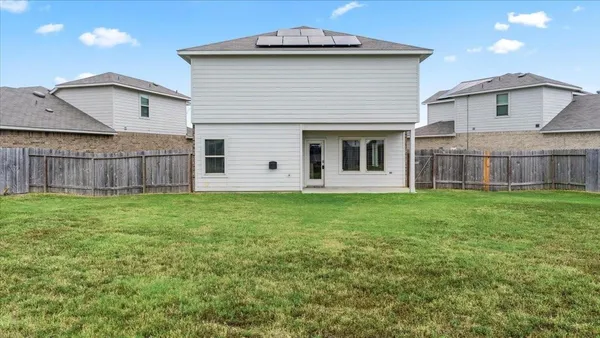 a view of a house with yard and sitting area
