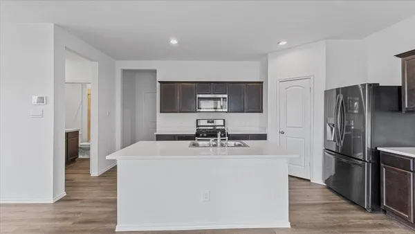 a kitchen with stainless steel appliances a refrigerator and a stove