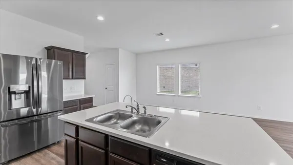 a kitchen with a sink and refrigerator