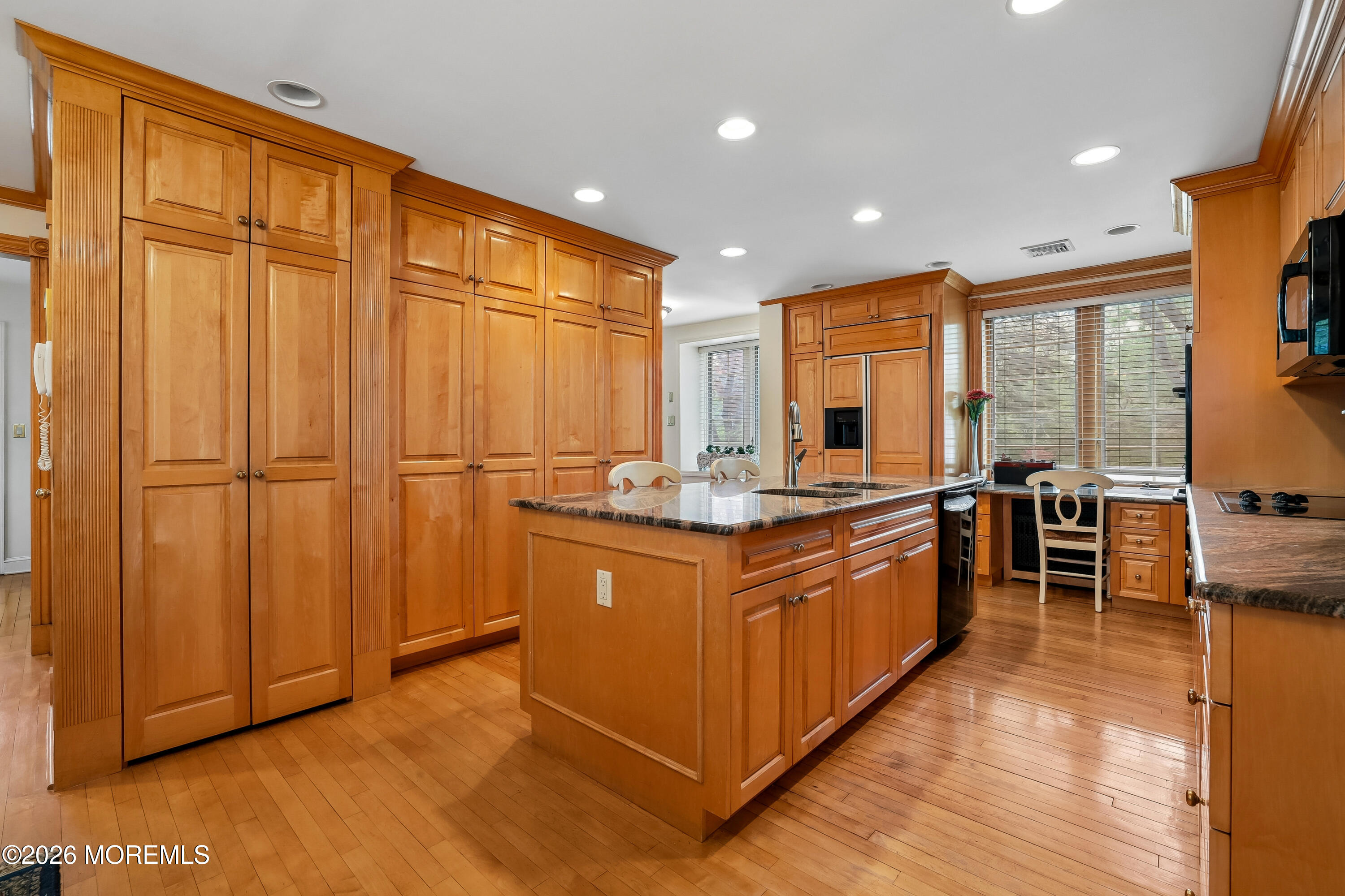 187 Hockhockson Road Colts Neck, NJ 07722 - Photo 19 of 55 a large kitchen with stainless steel appliances granite countertop wooden cabinets a sink and a large window