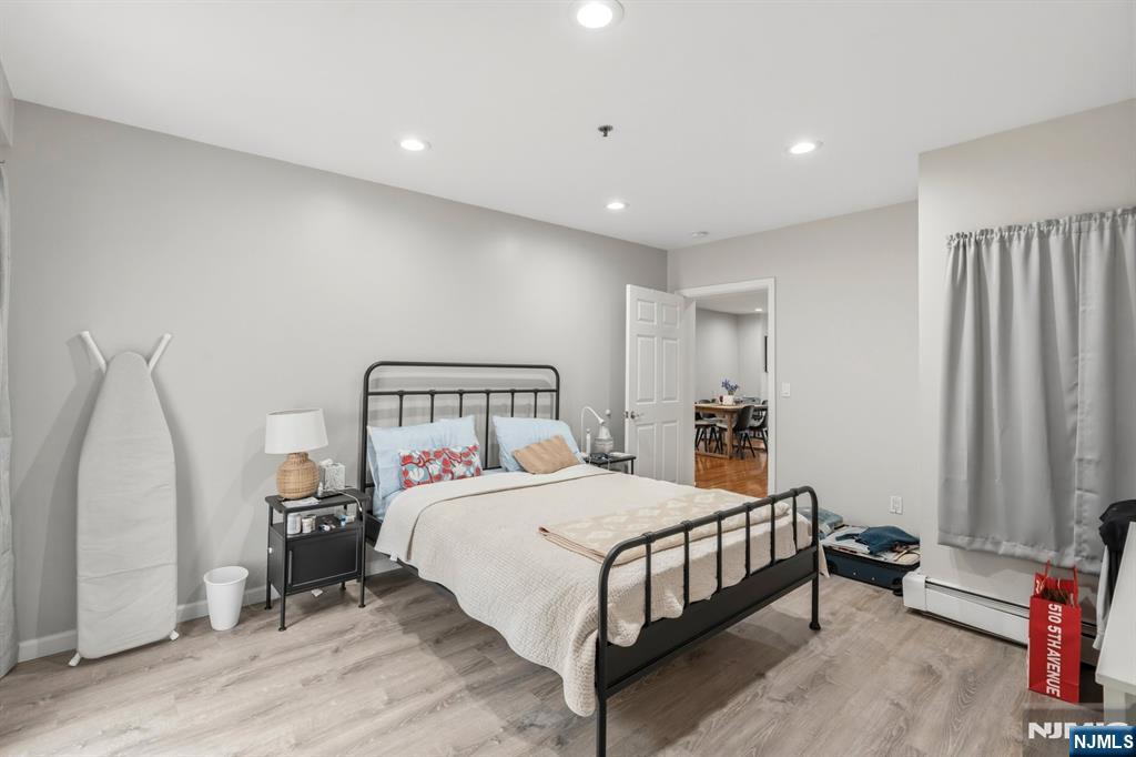 258 Old River Road Edgewater, NJ 07020 - Photo 12 of 32 a bedroom with a bed next to a window