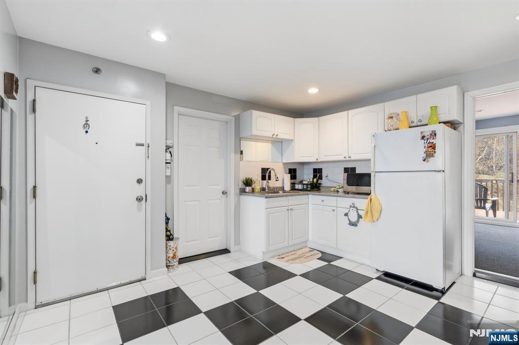 258 Old River Road Edgewater, NJ 07020 - Photo 24 of 32 a kitchen with stainless steel appliances a refrigerator and cabinets