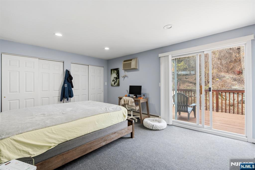258 Old River Road Edgewater, NJ 07020 - Photo 28 of 32 a bed room with a bed and a large window