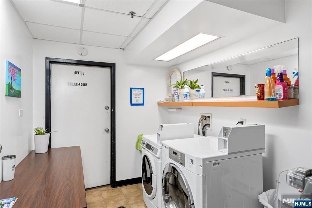 258 Old River Road Edgewater, NJ 07020 - Photo 30 of 32 a utility room with dryer washer and a view of living room
