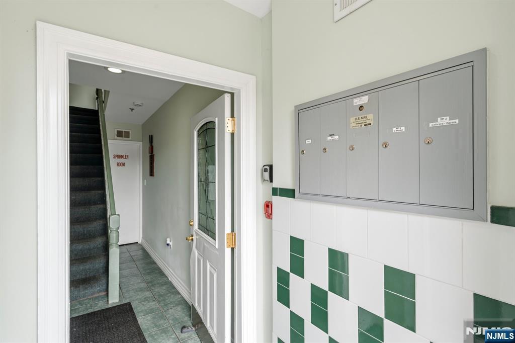 258 Old River Road Edgewater, NJ 07020 - Photo 3 of 32 a view of a hallway with wooden floor and staircase