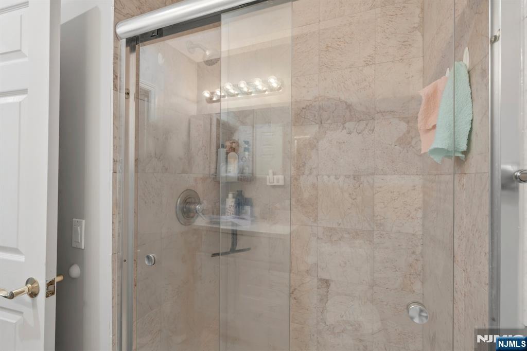258 Old River Road Edgewater, NJ 07020 - Photo 10 of 32 a bathroom with a glass shower door