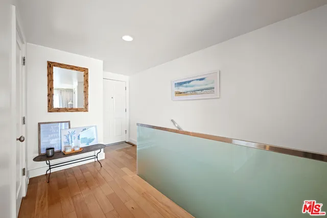a view of a room with wooden floor and cabinet
