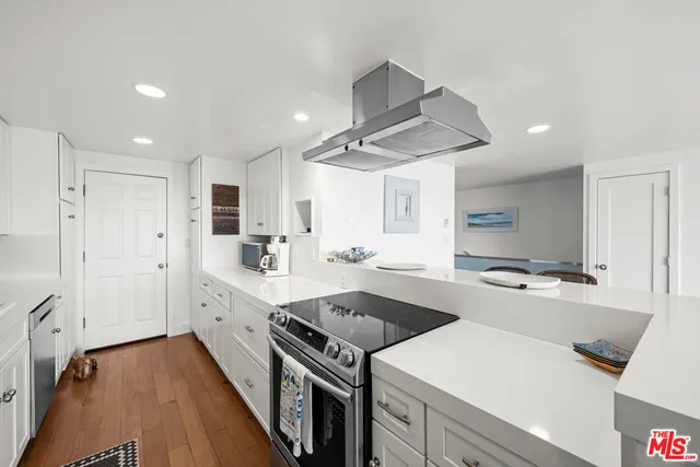 a kitchen with a stove a sink and a refrigerator