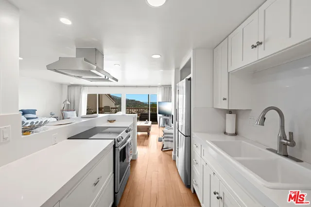 a kitchen with a sink stove and refrigerator