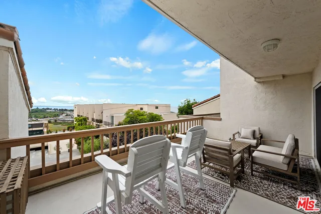 a view of a balcony with furniture