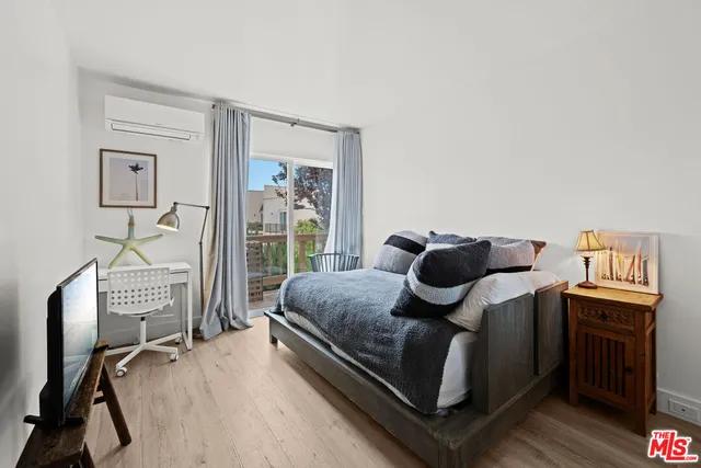 a bed sitting in a bedroom next to a window