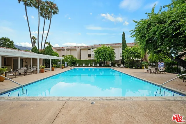 a house with swimming pool in front of it