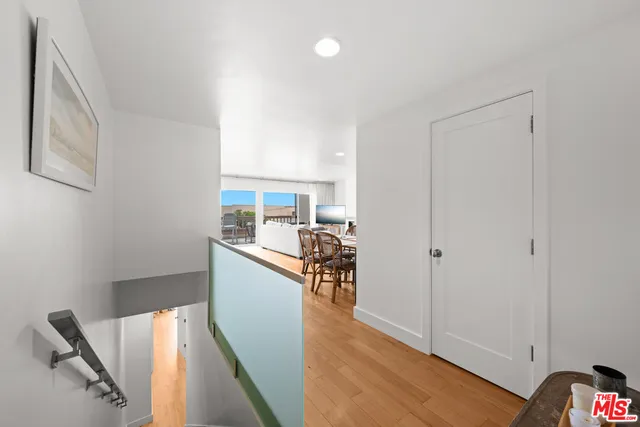 a kitchen with a sink and wooden floor