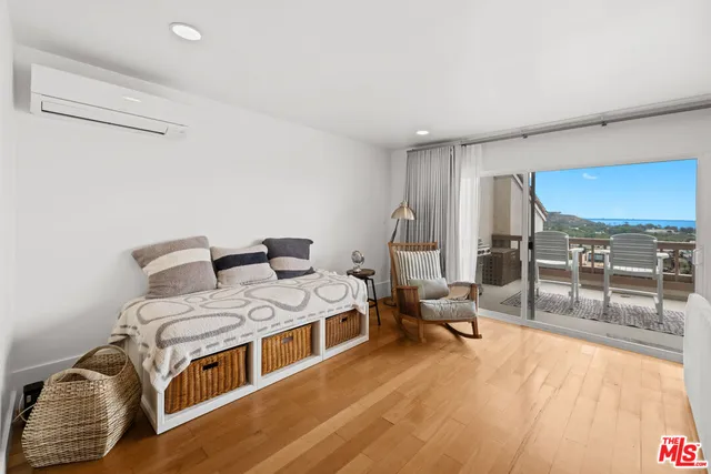 a bed room with a bed and a view of couch