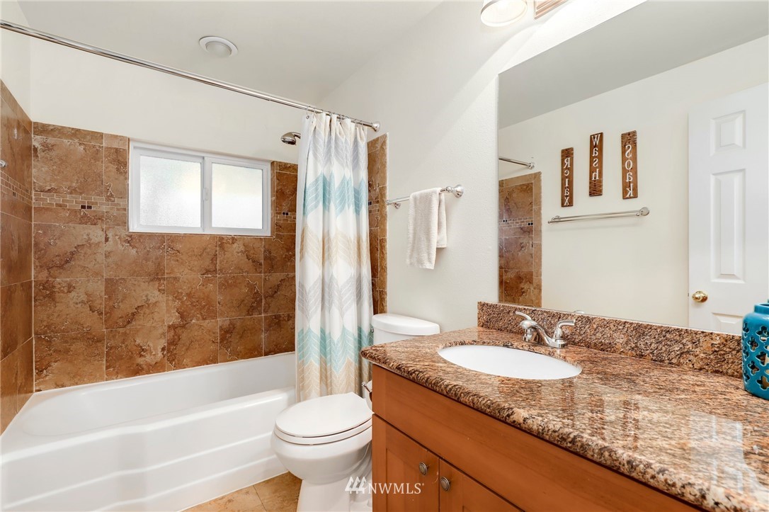 24118 2nd Place West Bothell, WA 98021 - Photo 14 of 25 a bathroom with a granite countertop sink toilet mirror and bathtub