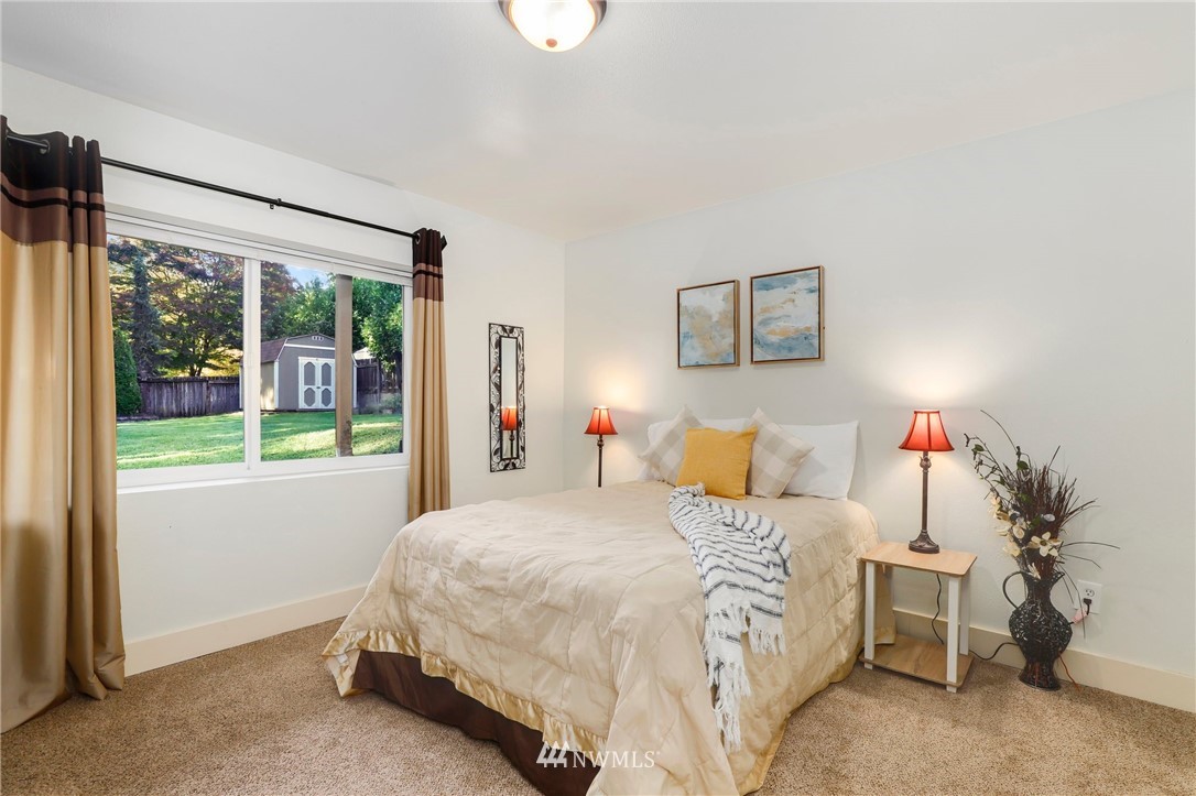 24118 2nd Place West Bothell, WA 98021 - Photo 19 of 25 a bedroom with a bed and a large window