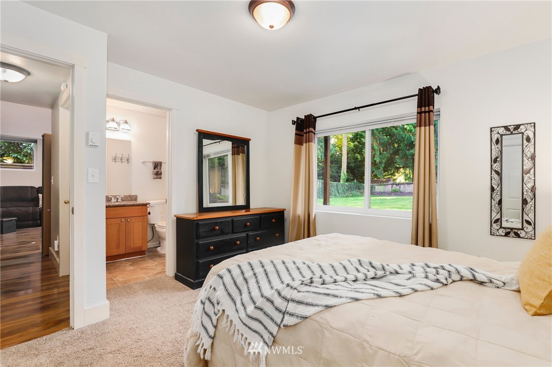 24118 2nd Place West Bothell, WA 98021 - Photo 20 of 25 a bedroom with a bed and large windows