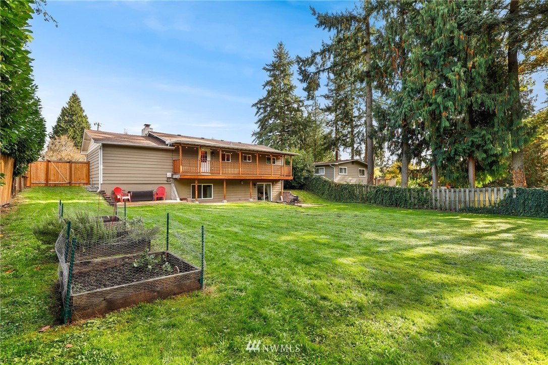 24118 2nd Place West Bothell, WA 98021 - Photo 24 of 25 a view of a house with a big yard potted plants and large tree