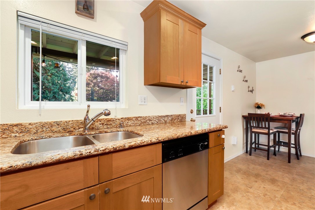24118 2nd Place West Bothell, WA 98021 - Photo 9 of 25 a kitchen with granite countertop a sink and a stove