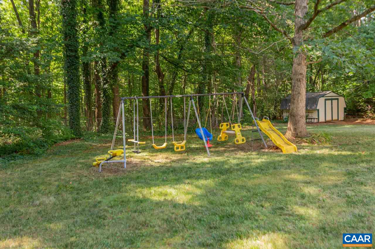 194 Ruckersville Heights Road Ruckersville, VA 22968 - Photo 11 of 38 a view of a backyard with a slide and a child swing