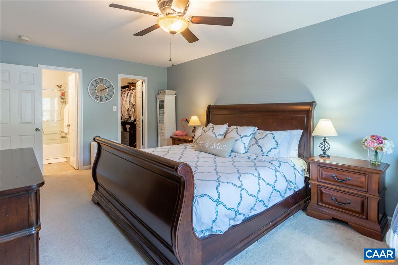 194 Ruckersville Heights Road Ruckersville, VA 22968 - Photo 29 of 38 a bedroom with a bed and a chandelier