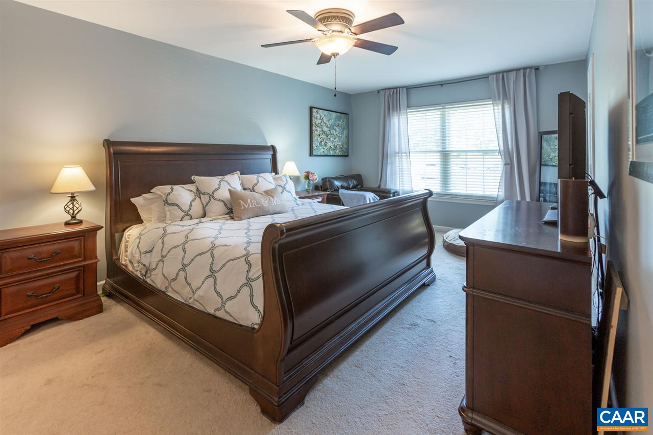 194 Ruckersville Heights Road Ruckersville, VA 22968 - Photo 31 of 38 a bedroom with a bed and a chandelier